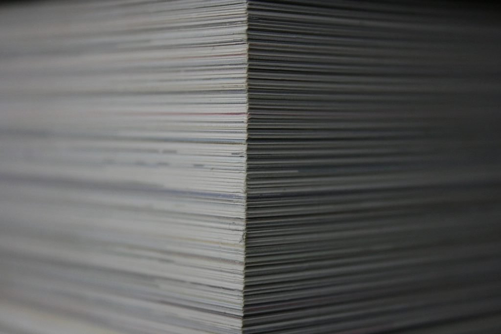 The cut edges of a deep stack of printed sheets, seen from the side