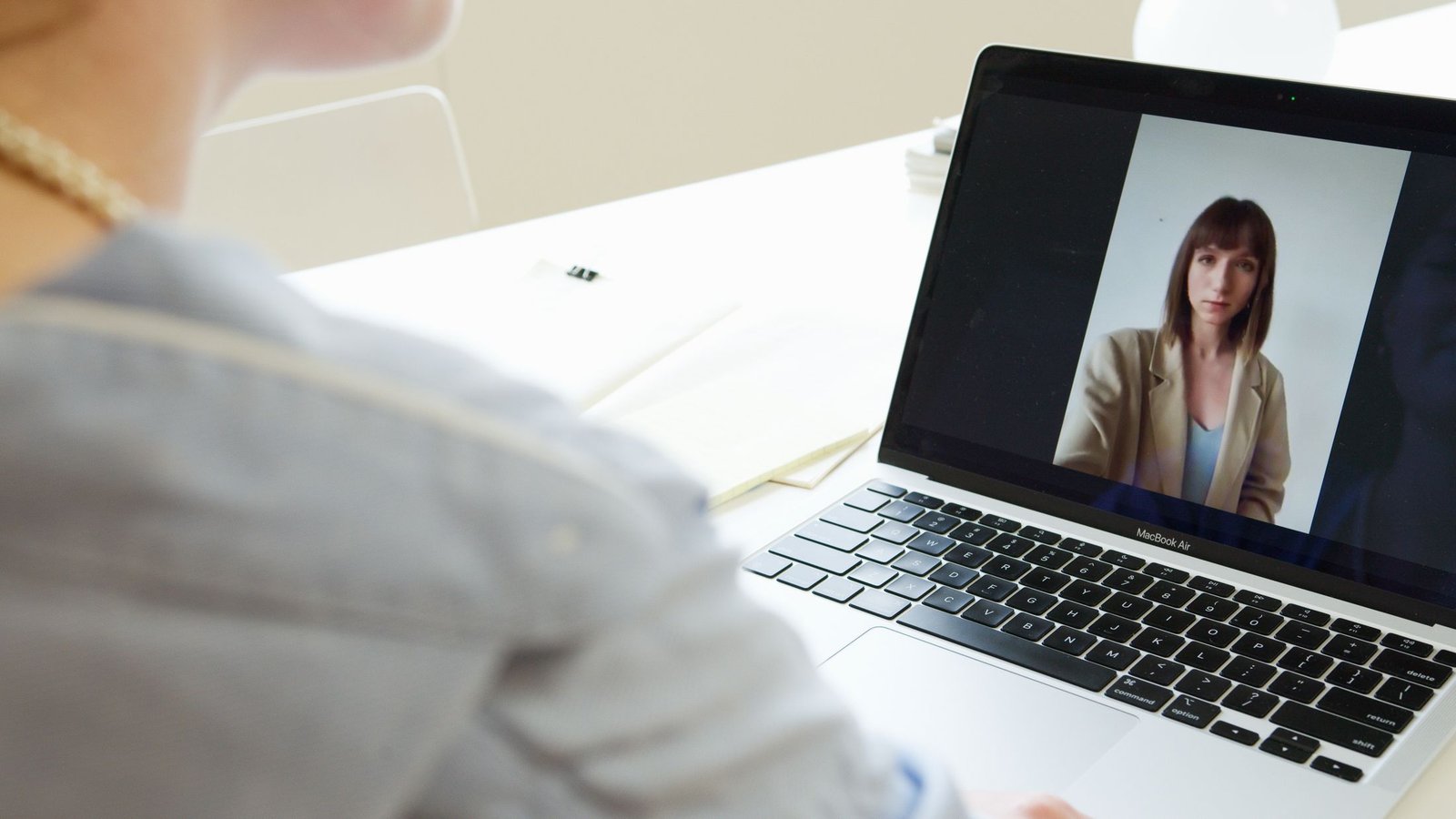 A person signing a document during a video call